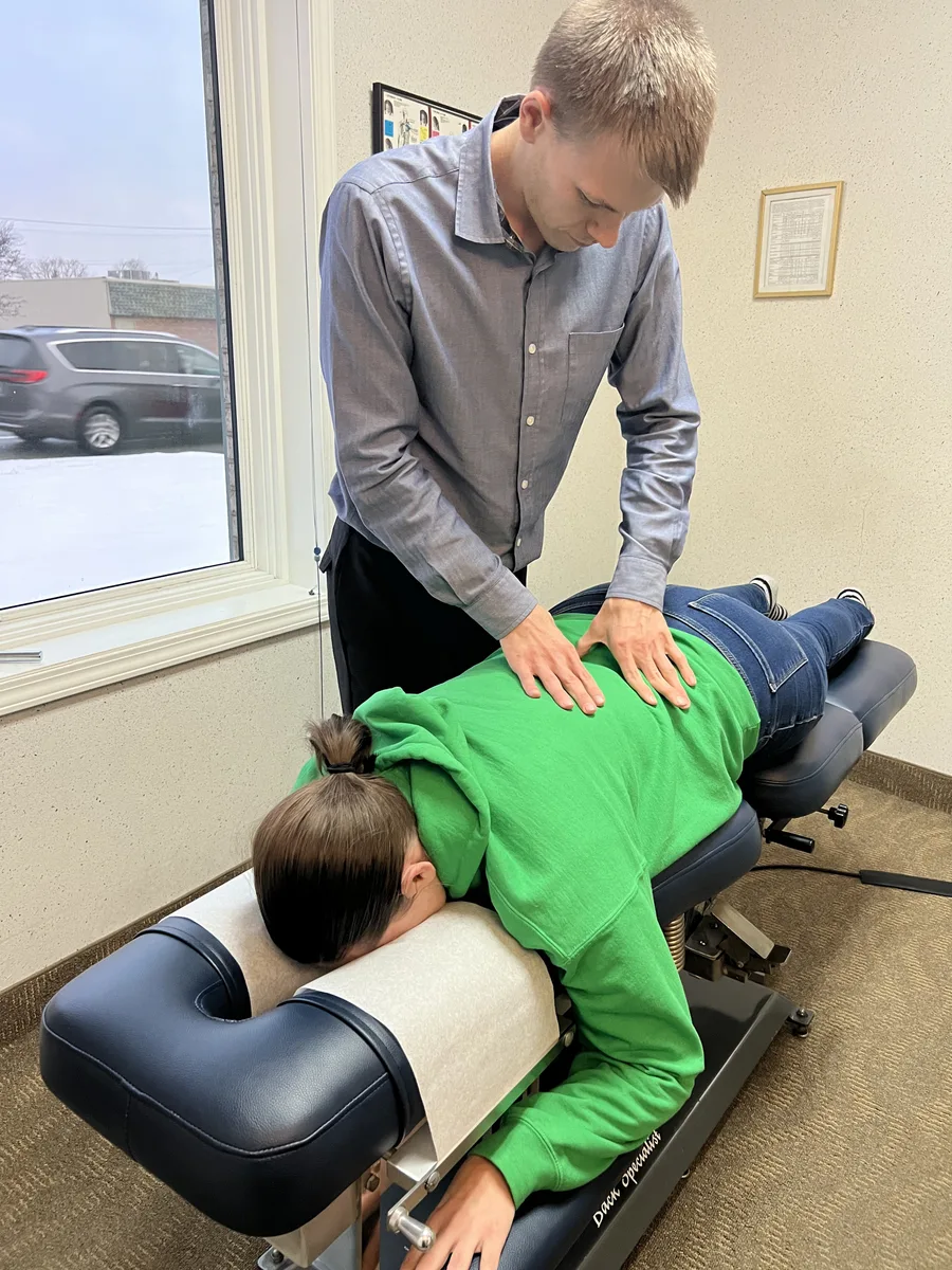 Dr. Jonathan Waltman performing a chiropractic adjustment